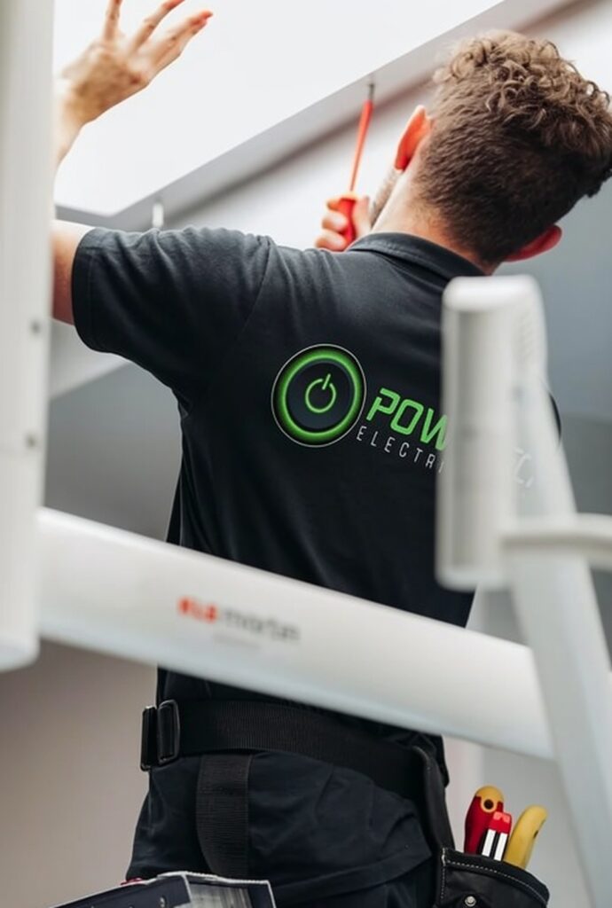 electrician-working-on-ceiling-light-overheating-issues